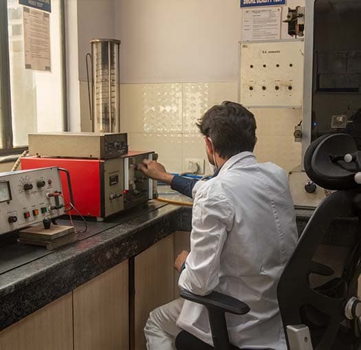 Periwal Polymers technician running a smoke density test in the plant lab